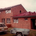 Ford Cortina with trailer parked in front of a house still in construction