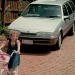 Holden VL Commodore parked on a driveway with a child on a bicycle in the foreground