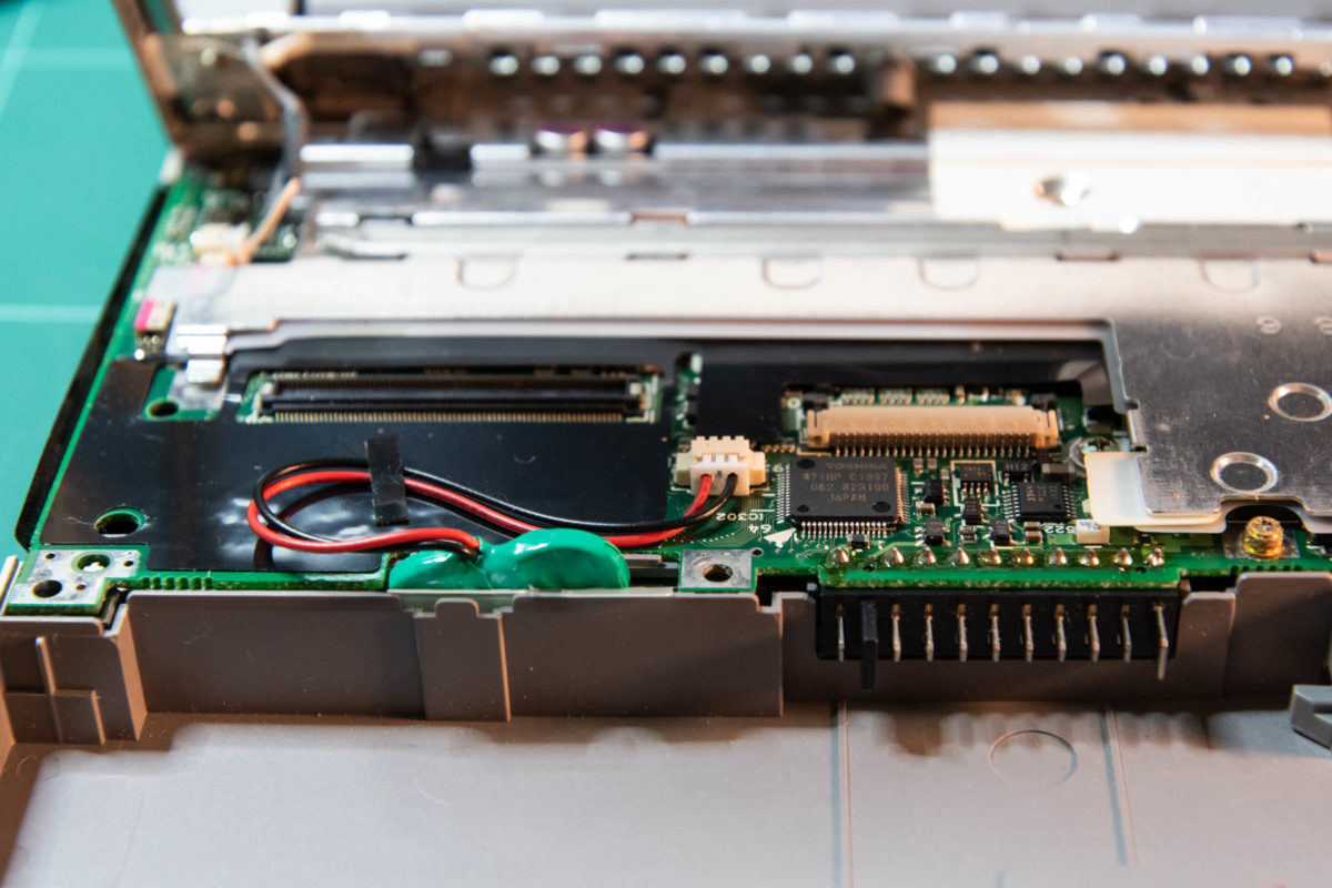 The new battery tucked neatly into its own place within the guts of the Libretto 100CT.